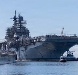 The USS America arrives at the General Dynamics National Steel and Shipbuilding Company shipyard